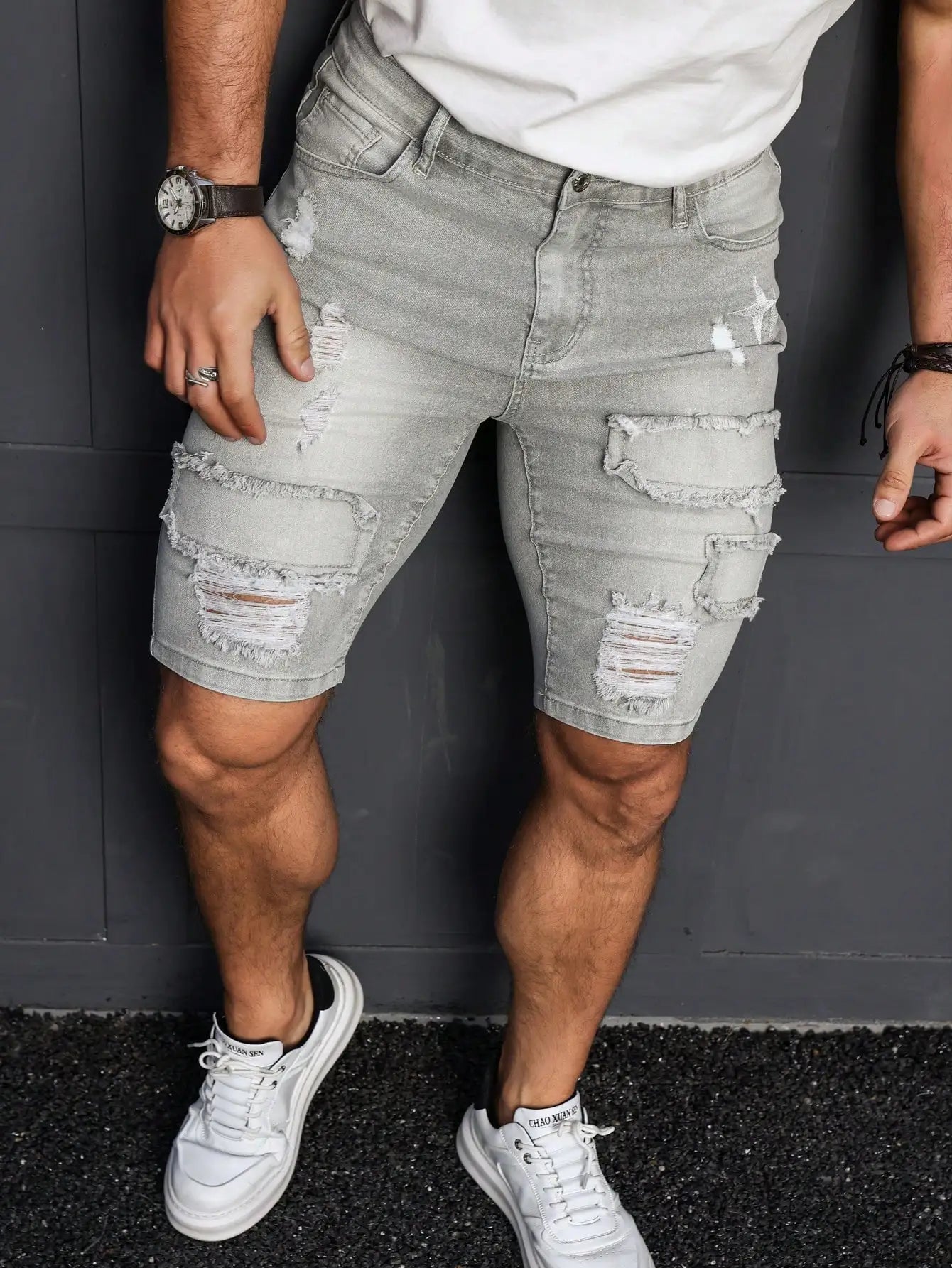 Men's Summer Denim Shorts. Light Gray Ripped Denim Shorts. Ripped and Frayed Design. Street Trend and Casual Style
