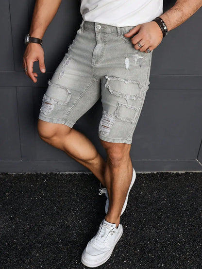 Men's Summer Denim Shorts. Light Gray Ripped Denim Shorts. Ripped and Frayed Design. Street Trend and Casual Style