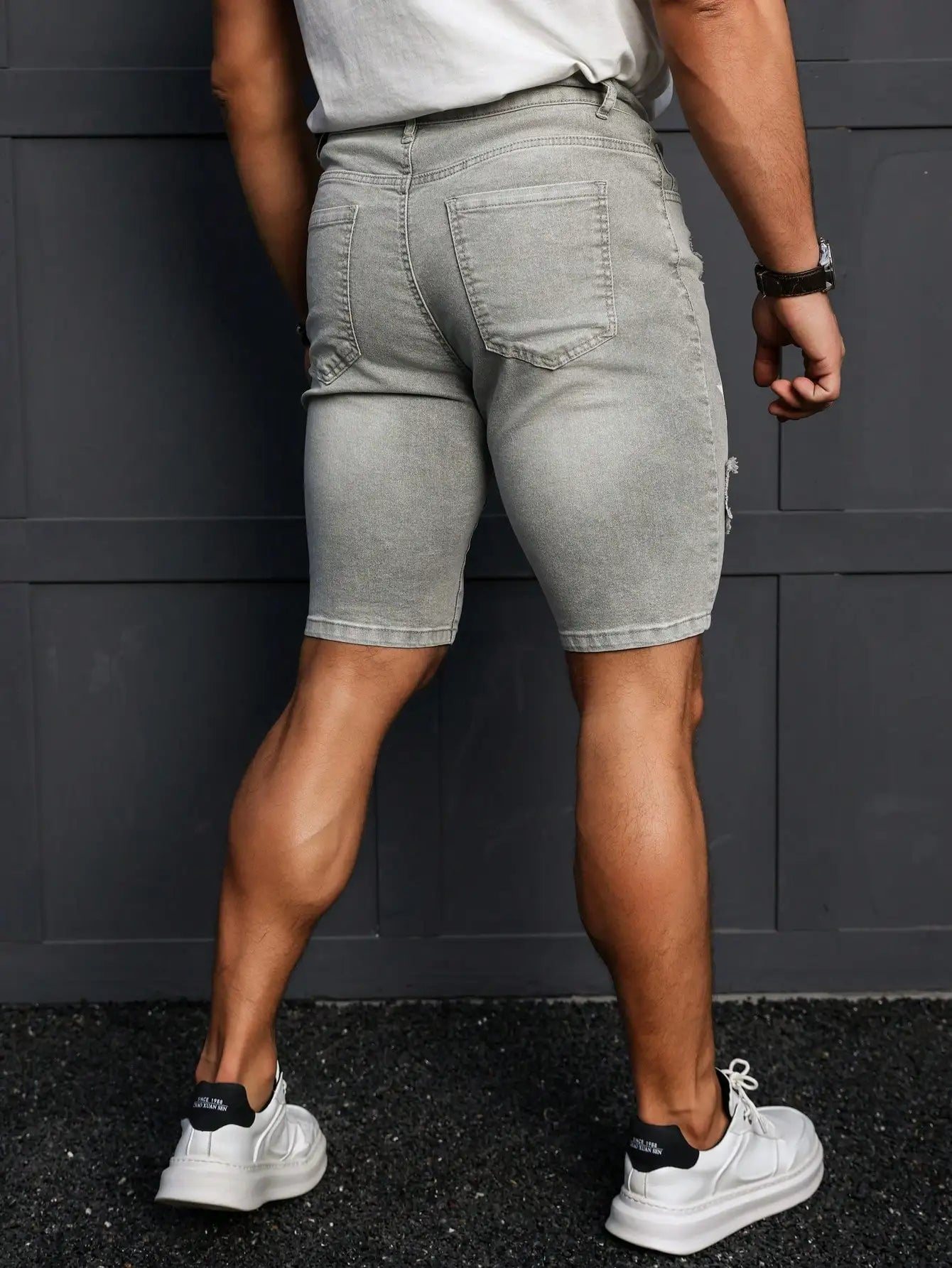 Men's Summer Denim Shorts. Light Gray Ripped Denim Shorts. Ripped and Frayed Design. Street Trend and Casual Style