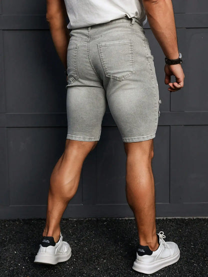 Men's Summer Denim Shorts. Light Gray Ripped Denim Shorts. Ripped and Frayed Design. Street Trend and Casual Style